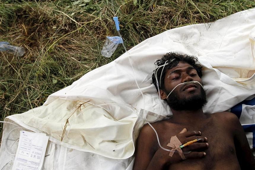 A migrant who arrived today by boat, part of a group of Rohingya and Bangladeshis, receives medical assistance at an aid station in Kuala Langsa in Indonesia's Aceh Province on May 15, 2015. Nearly 900 "boat people" were brought ashore in Indonesia a