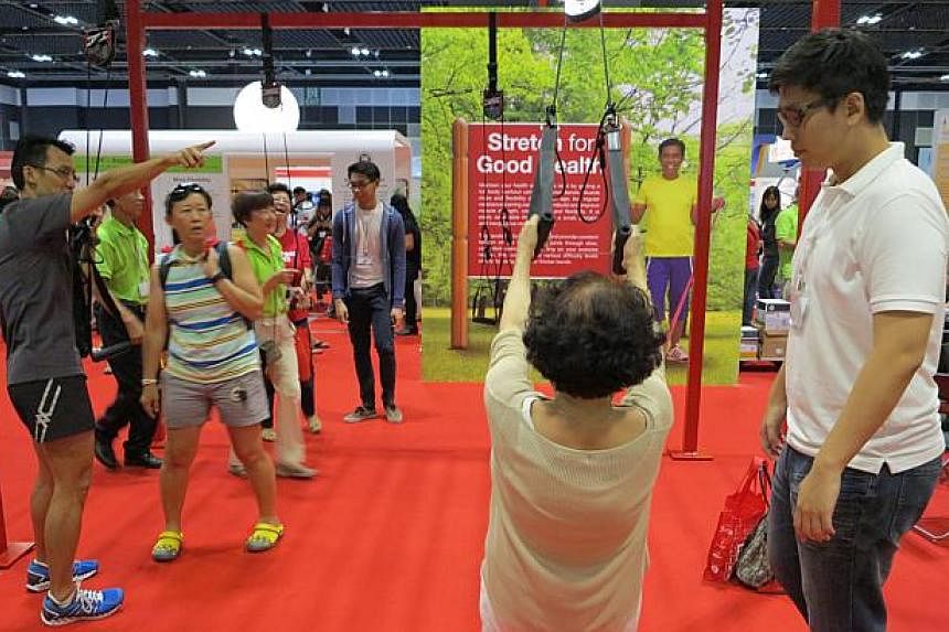 &nbsp;An old lady trying out some exercises at the 50plus Expo at Suntec Convention and Exhibition Centre on Saturday, May 16, 2015.&nbsp;-- ST PHOTO: YEO SAM JO