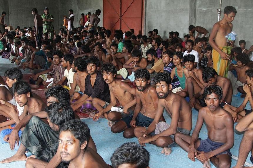 A group of rescued migrants at a confinement area in the fishing town of Kuala Langsa in Aceh province yesterday. More than 700 Rohingya and Bangladeshi migrants arrived in Indonesia yesterday after they were rescued by fishing boats when their vesse