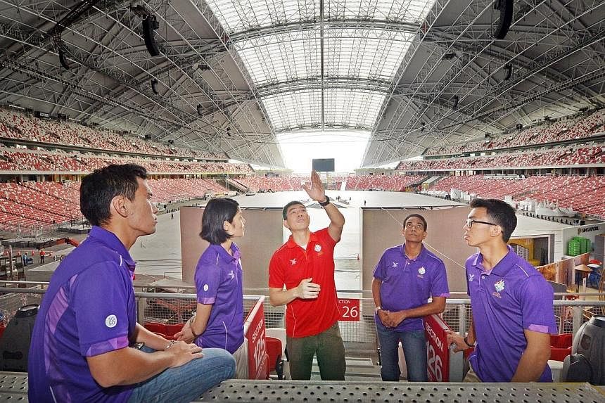 Chief Artillery Officer Lawrence Lim (centre) having a discussion with (from left) Captain Ang Wee Kiong, 26, Captain Hong Ruoyi, 26, First Warrant Officer Nedunsezhian, 48, and Lieutenant Demerin Allen Christian Gadon, 21, at the National Stadium on