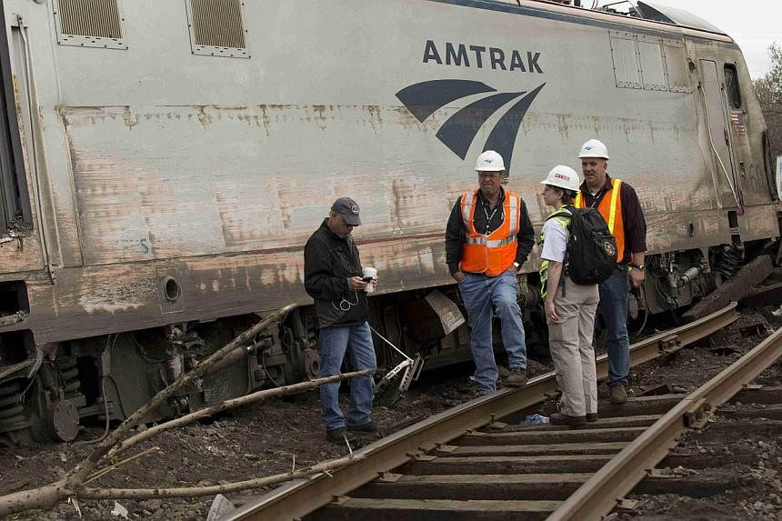 National Transportation Safety Board officials on the scene of the Amtrak derailment in Philadelphia on May 13, 2015. The train and a separate commuter train in the vicinity may have been hit by projectiles of some kind shortly before the wreck, a US