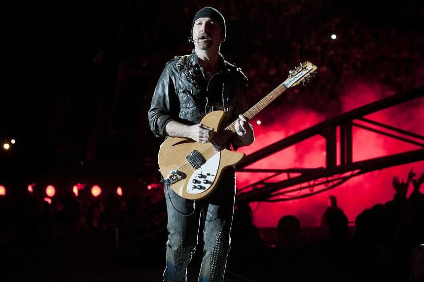 U2 guitarist The Edge (above, in a 2011 file photo) apparently did not see the part of the stage that is his own namesake as he tumbled on the first night of the veteran Irish rockers' tour. -- PHOTO: AFP