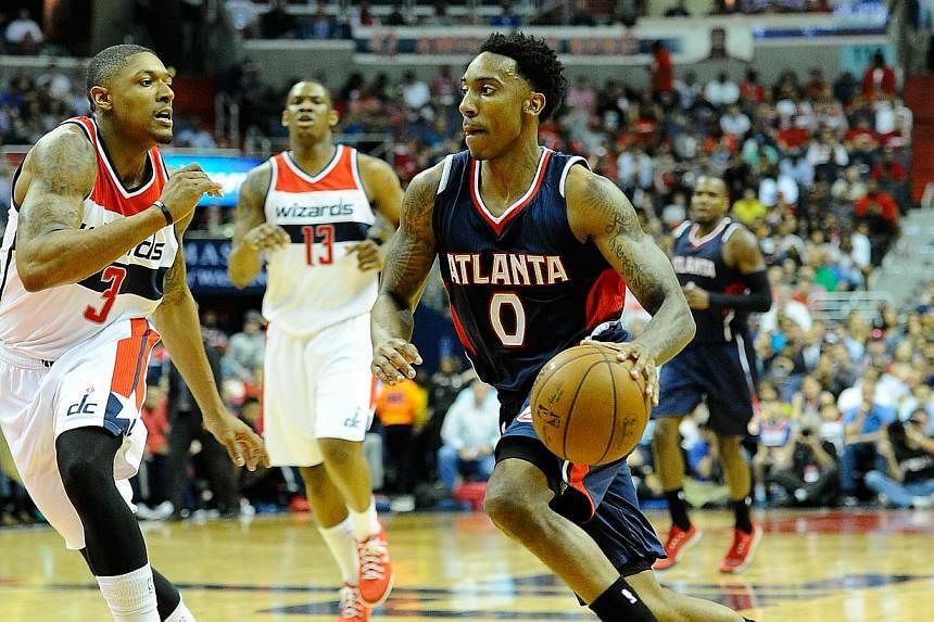 Atlanta Hawks guard Jeff Teague (right) dribbles past Washington Wizards guard Bradley Beal (left) during the first half in game six of the second round of the NBA Playoffs at Verizon Center. -- PHOTO: USA TODAY SPORTS &nbsp;