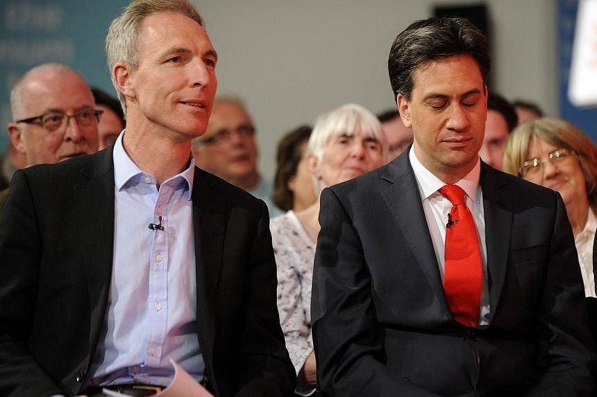 Scottish Labour Party leader Jim Murphy (left) sits with opposition&nbsp;Labour Party leader Ed Miliband (right)&nbsp;at a Labour Party general election campaign rally in Glasgow, Scotland, on May 1, 2015. -- PHOTO: AFP