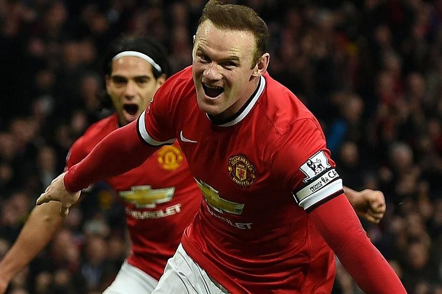 Manchester United's Wayne Rooney celebrates scoring a penalty during a match against Sunderland on Feb 28, 2015.&nbsp;Manchester United captain Rooney and left back Luke Shaw will miss the Premier League game against Arsenal on Sunday due to injury. 