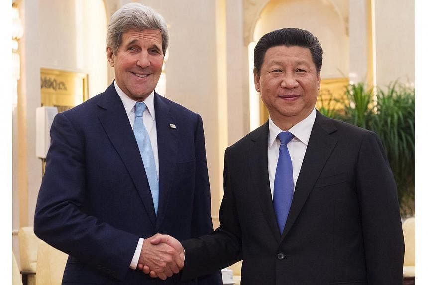 Chinese President Xi Jinping and US Secretary of State John Kerry shake hands prior to holding a meeting at the Great Hall of the People in Beijing, China on&nbsp;May 17, 2015. China's ties with the United States remain stable, Mr Xi said on Sunday, 