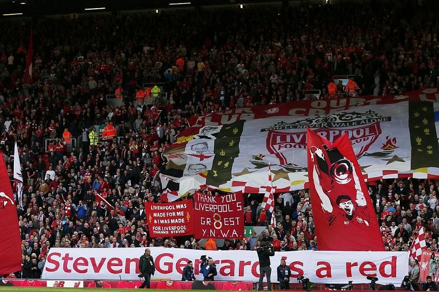 Liverpool fans with banners for Steven Gerrard before the match. -- PHOTO: REUTERS