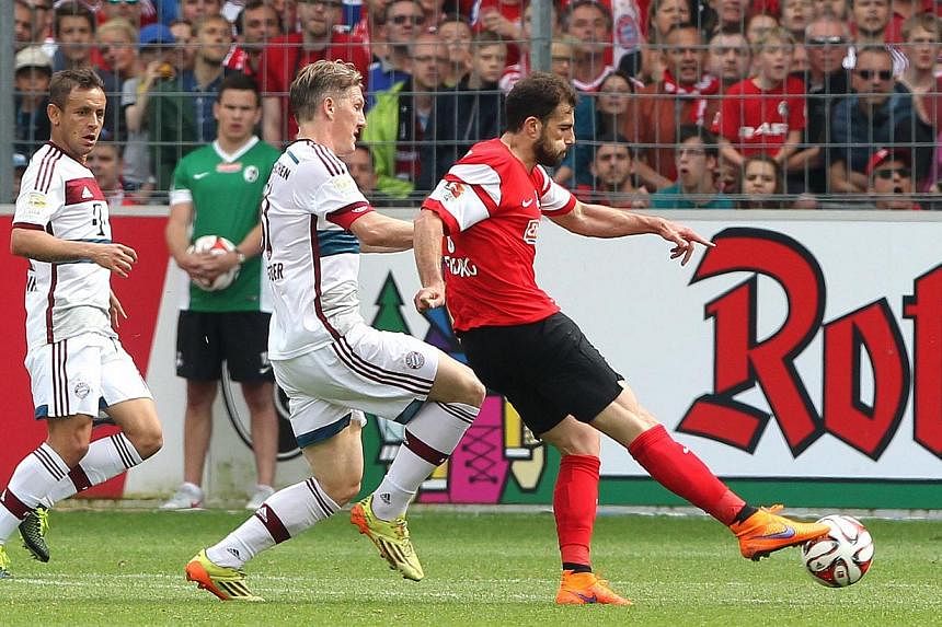Freiburg's Swiss forward Admir Mehmedi (right) scores against Bayern Munich ion May 16, 2015. -- PHOTO: AFP&nbsp;