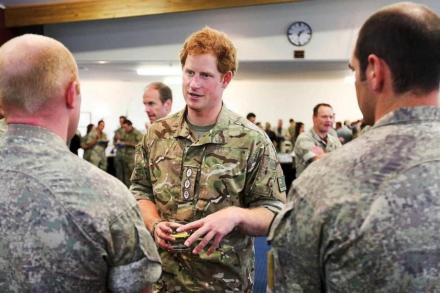 Britain's Prince Harry speaks to military personnel during his visit to Linton Military Camp near Palmerston North, on May 13, 2015.&nbsp;The British Royal called for the return of national service in his home country, crediting a military career for