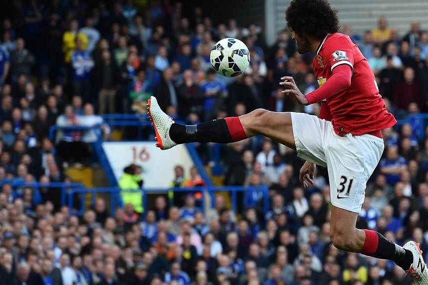 Manchester United's Belgian midfielder Marouane Fellaini jumps to control the ball during the English Premier League football match between Chelsea and Manchester United at Stamford Bridge in London on April 18, 2015. -- PHOTO: AFP&nbsp;