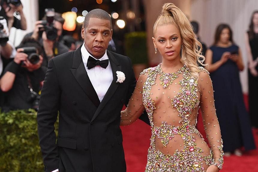 Jay Z (left) with wife and pop star Beyonce at the Met Gala in New York on May 4, 2015. The rap mogul has been quietly using his wealth to post bail for people arrested in protests across the US, said an author close to him. -- PHOTO: AFP