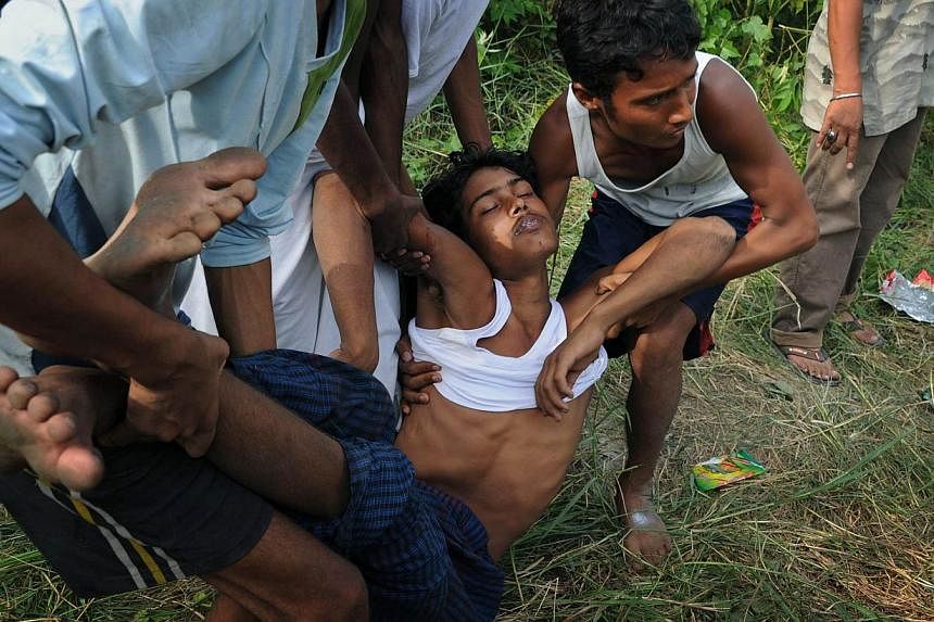 A rescued migrant being carried to an ambulance after his arrival at Kuala Langsa in Aceh last Friday. With thousands of boat people from Myanmar having been stranded at sea in recent weeks, such images could well strain its relations with the West a