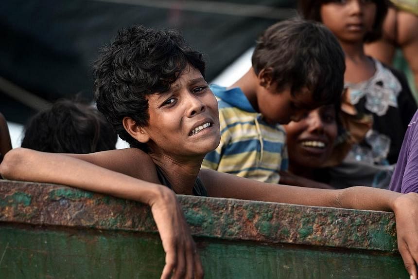 A Rohingya migrant crying as he sits with others in a boat drifting in Thai waters off the southern island of Koh Lipe in the Andaman Sea, on May 14, 2015. Malaysia's National Security Council chairman Shahidan Kassim has defended the country against