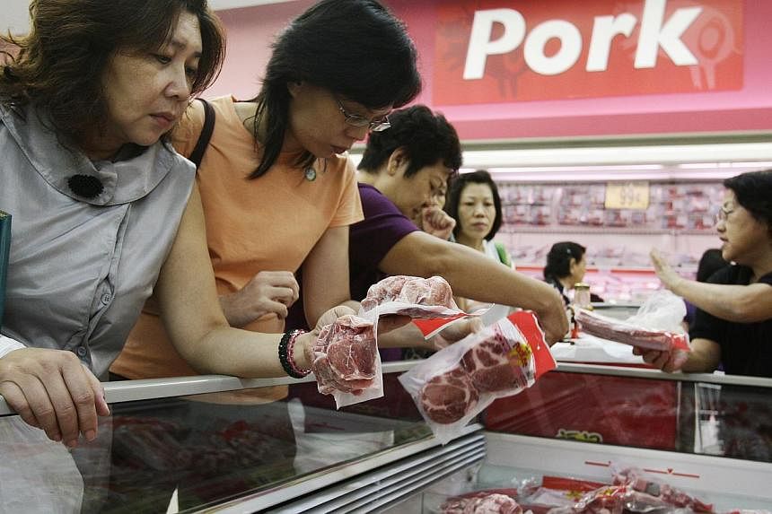 Shoppers looking over frozen pork products at NTUC Fairprice in Ang Mo Kio Hub. The Agri-Food &amp; Veterinary Authority (AVA) recently approved the import of frozen pork from a slaughterhouse in Sarawak, marking the partial end of a more-than-decade