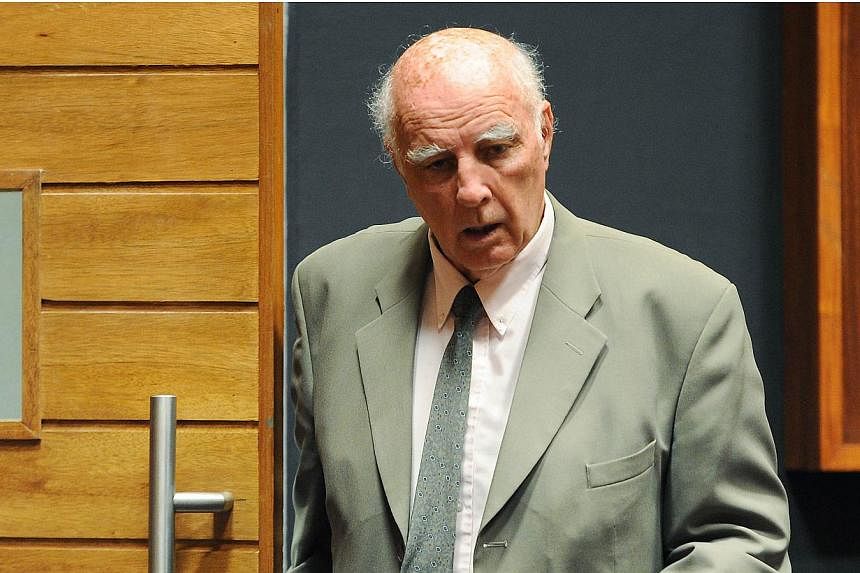 Australian-born former tennis Grand Slam champion Bob Hewitt walks through the Palm Ridge court where he was found guilty of rape and indecent assault on March 23, 2015 in Johannesburg.&nbsp;Hewitt was sentenced to six years in jail in South Africa o