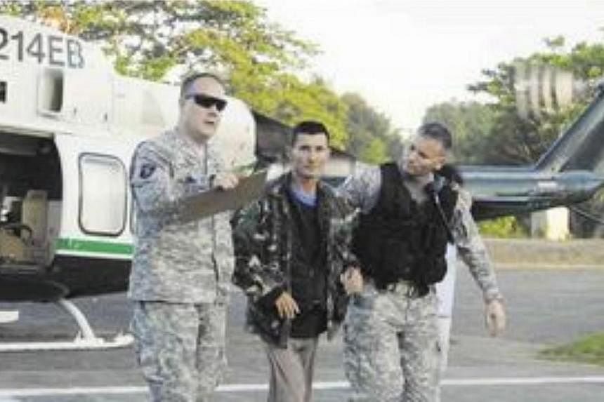 Australian Warren Rodwell (centre) after he was released by Abu Sayyaf militants on March 23, 2013. A Philippine policeman has been arrested over the kidnapping-for-ransom of Mr Roswell, police said on Monday, May 18, 2015. -- PHOTO: COURTESY OF WEST