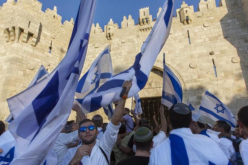 Israelis stop to sing and dance as they stop outside the Damascus Gate in East Jerusalem before marching into the Moslem Quarter of Jerusalem's Old City on Jerusalem Day on Sunday 17 May 2015. -- PHOTO: EPA