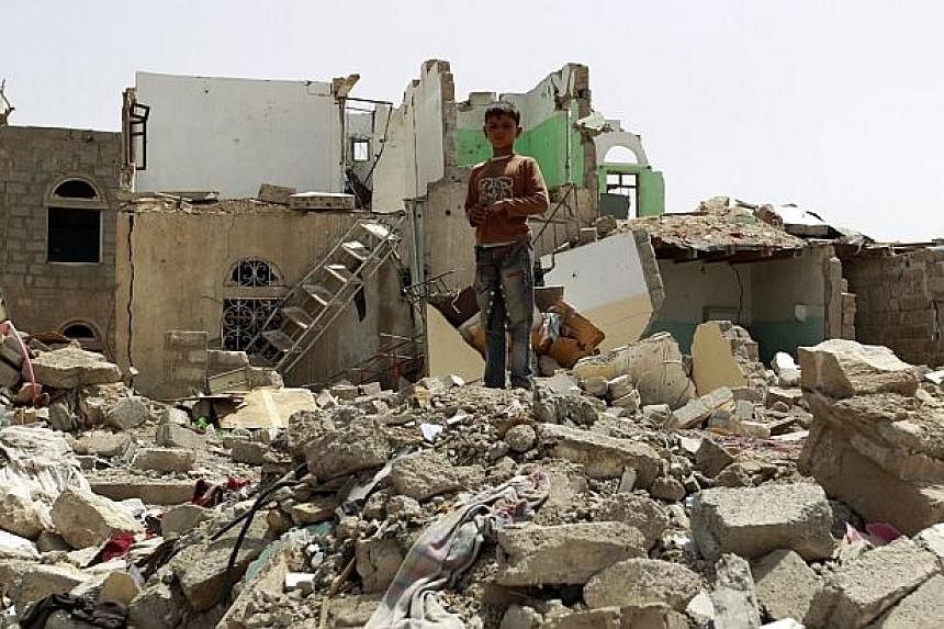 &nbsp;A Yemeni boy stands amidst the rubble of houses destroyed by Saudi-led air strike on a residential area last month, in the capital Sanaa, on Monday. Saudi-led coalition warplanes resumed strikes on rebel positions in southern Yemen after a five