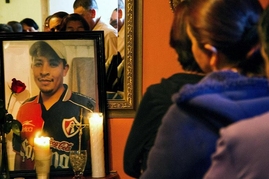 Relatives and friends of Mexican Ruben García Villalpando taking part in a mass at his sister's house, in the town of Nuevo Porvenir, in Durango State on Feb 28 2015. -- PHOTO: AFP&nbsp;