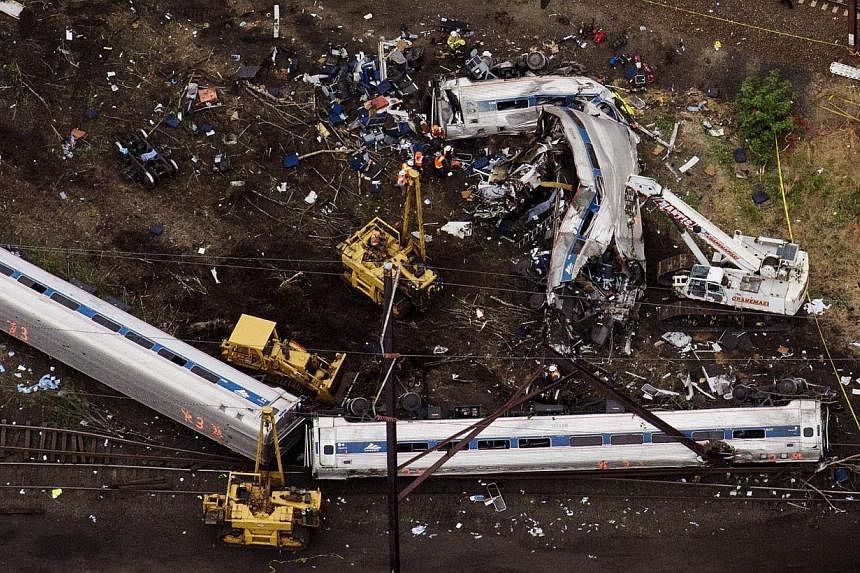 Emergency workers looking through the remains of a derailed Amtrak train in Philadelphia, Pennsylvania. -- PHOTO: REUTERS&nbsp;