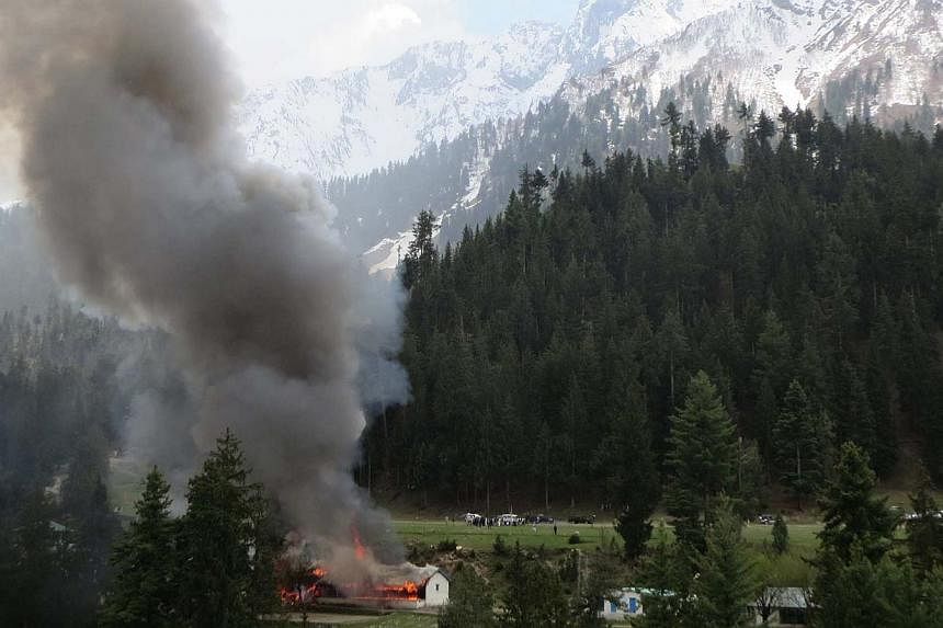 Flame and smoke rising from the site where a Pakistani military helicopter crashed in the northern area of Gilgit on May 8, 2015. -- PHOTO: AFP