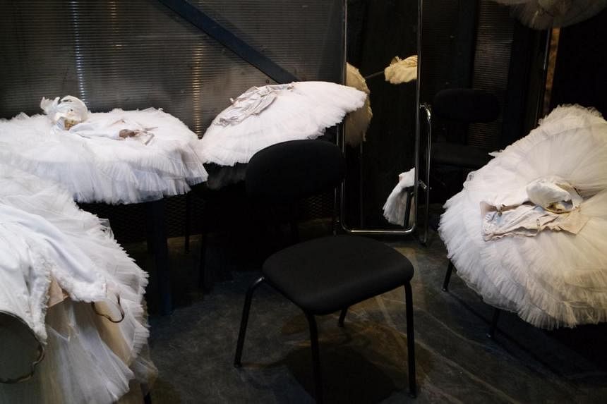Piles of white swan tutus sit in a changing room, waiting for the dancers to claim them. -- ST PHOTO: LISABEL TING