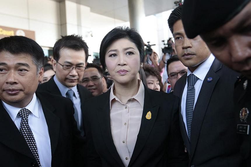 Former Thai prime minister Yingluck Shinawatra (centre) leaving the Supreme Court in Bangkok, Thailand, on May 19, 2015. -- PHOTO: EPA&nbsp;
