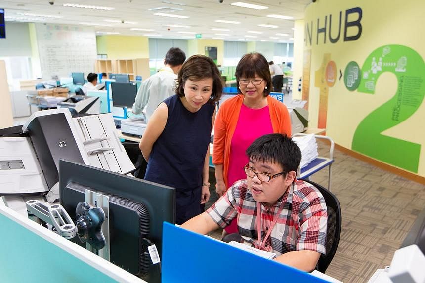 (From left) UOB Group head of technology and operations Susan Hwee, Autism Resource Centre president Denise Phua and UOB Scan Hub clerical assistant Feng Zhi Hua. People with autism account for about one-third of the 53 employees at the Scan Hub, whe