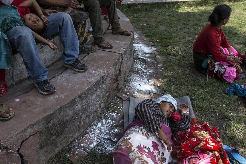 Maya Tamang, 20, sleeps next to her one-day-old daughter at a makeshift shelter outside Bhaktapur hospital in Bhaktapur, Nepal, May 13, 2015. -- PHOTO: REUTERS