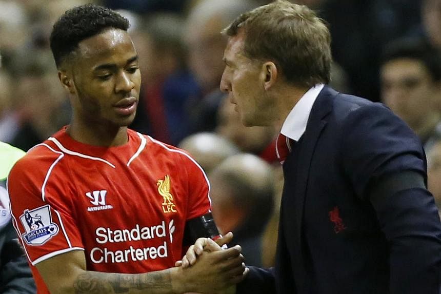 Liverpool winger Raheem Sterling (left) could add to manager Brendan Rodgers' (right) Anfield woes, as speculation mounts that he could hand in a transfer request. -- PHOTO: REUTERS