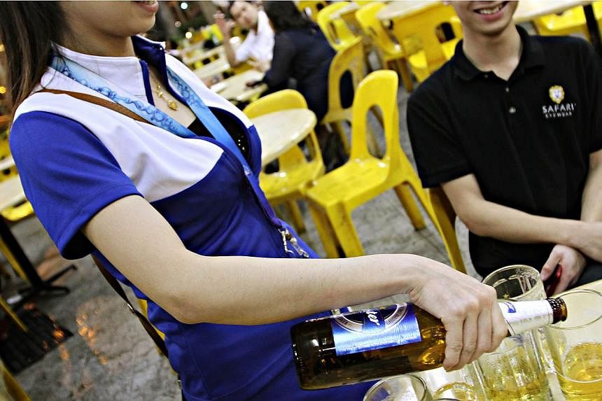 Breweries have been asked to withdraw their beer promoters from the 107 markets and hawker centres managed by the National Environment Agency (NEA), The Straits Times understands.&nbsp;&nbsp;-- PHOTO: THE NEW PAPER&nbsp;