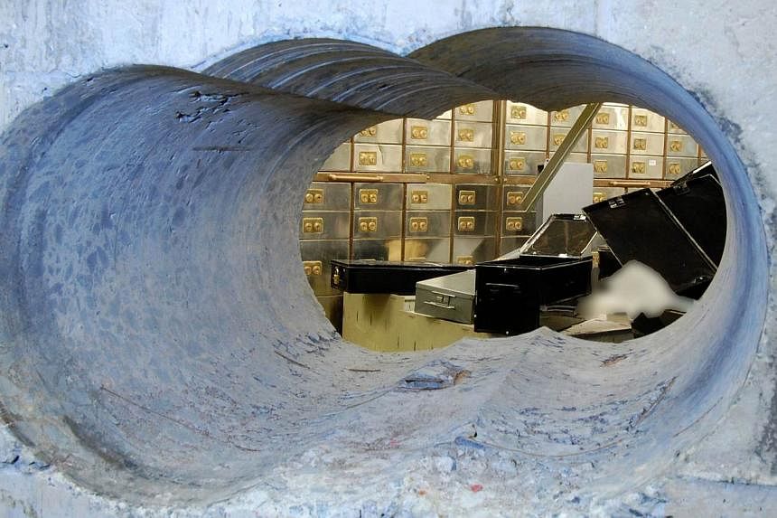 Holes bored through a half-metre thick concrete wall drilled to access a vault in a safe deposit centre in Hatton Garden, London. -- PHOTO: AFP/BRITISH METROPOLITAN POLICE&nbsp;