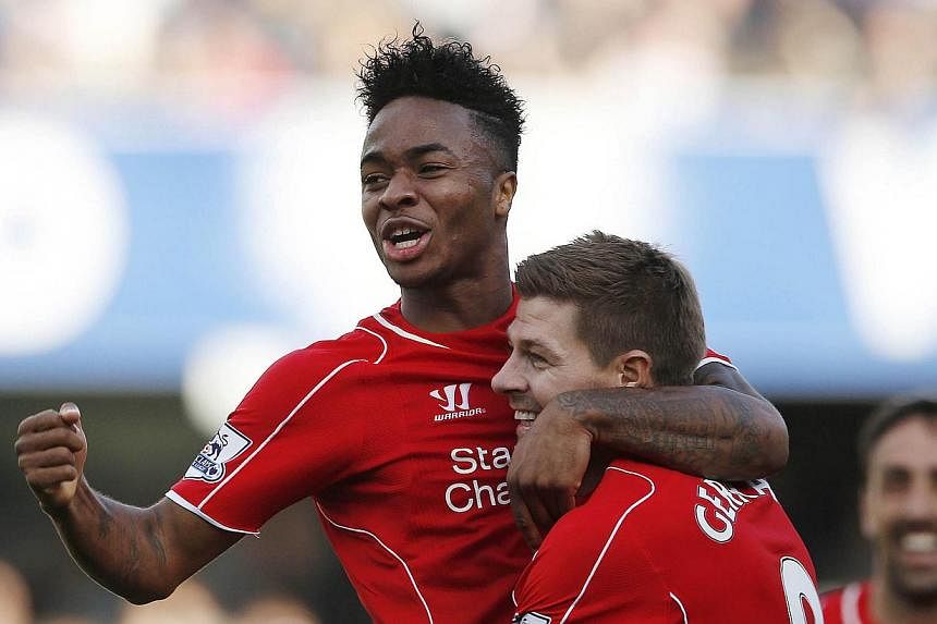 Raheem Sterling (left) celebrates with Steven Gerrard after Steven Caulker (not pictured) scores an own goal and the third for Liverpool on October 19, 2014. -- PHOTO: ACTION IMAGES &nbsp;