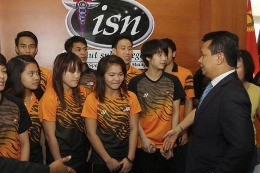Malaysia's SEA Games chef-de-mission Norza Zakaria (right) speaking with the Malaysian national divers at the National Institute of Sport in Bukit Jalil on May 8, 2015. Datuk Seri Norza said he wants the Malaysian contingent to toe the line at next m