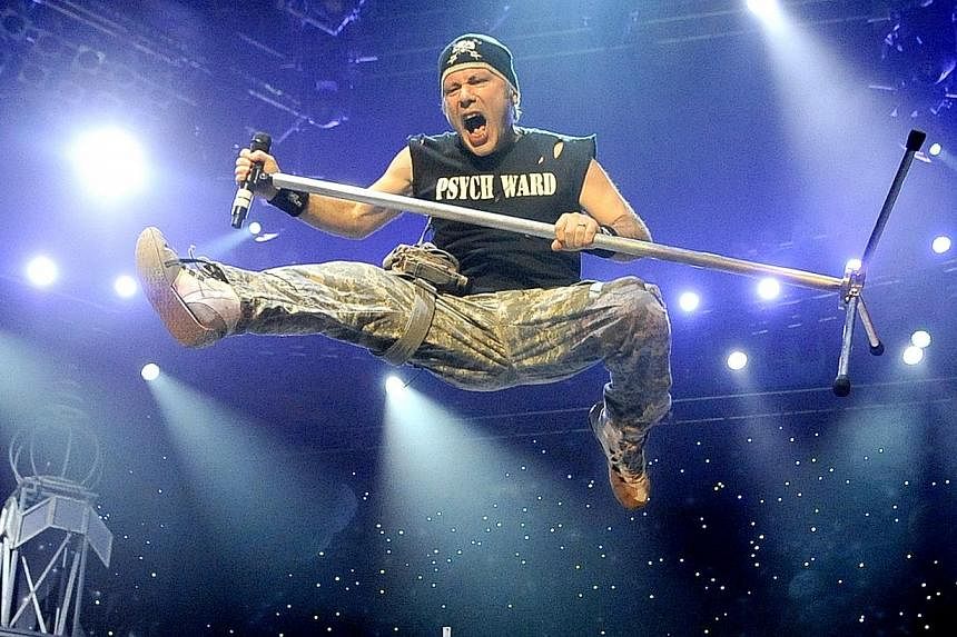 Charismatic frontman Bruce Dickinson roared and amped up the mood with his vocal histrionics and antics during heavy-metal band Iron Maiden’s concert at the Singapore Indoor Stadium in 2011.-- PHOTO:&nbsp;SPH