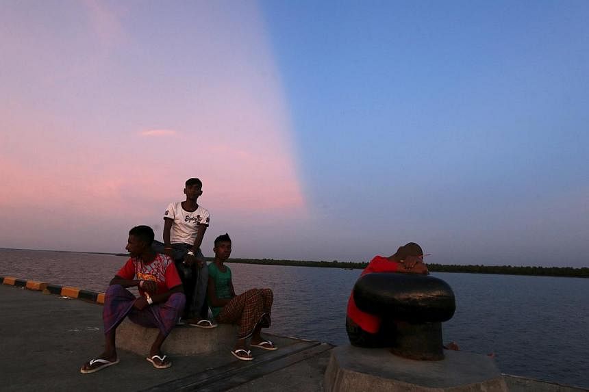 Rohingya migrants, who recently arrived in Indonesia by boat, enjoying the sunset at a shelter in Kuala Langsa, in Indonesia's Aceh Province, on May 19, 2015. -- PHOTO: REUTERS&nbsp;