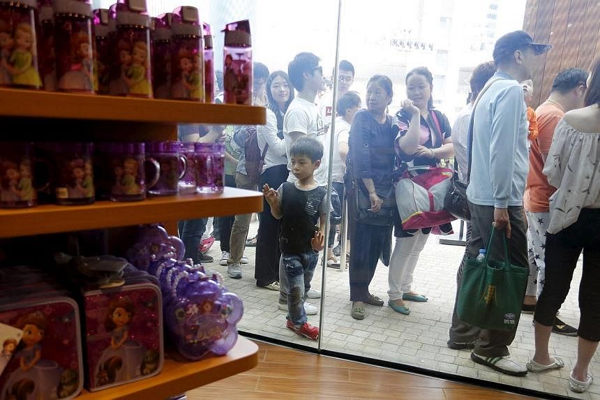 People queue to enter China's first Disney store at Pudong financial district in Shanghai&nbsp;on May 20, 2015. -- PHOTO: REUTERS