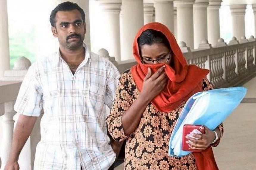 Nur Shila Kanan (right) and her husband Basheer Ahmad Maula Sahul Hameed, who stole from the bank accounts of four MH370 passengers. -- PHOTO: THE STAR/ASIA NEWS NETWORK