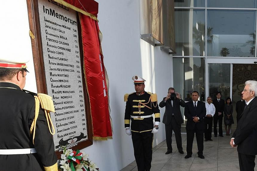 Italian President Sergio Mattarella (right) lays a wreath at a monument displaying the names of those killed in the Bardo Museum attack, during his visit to Tunis on May 18, 2015. Italian police have arrested a Moroccan man suspected of taking part i