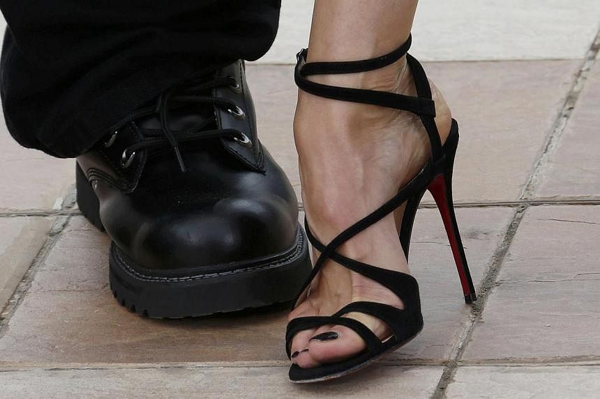 The shoes of jury members, actress Sophie Marceau (right) and film director Guillermo del Toro, are pictured as they pose during a photocall before the opening of the 68th Cannes Film Festival on May 13, 2015. -- PHOTO: REUTERS