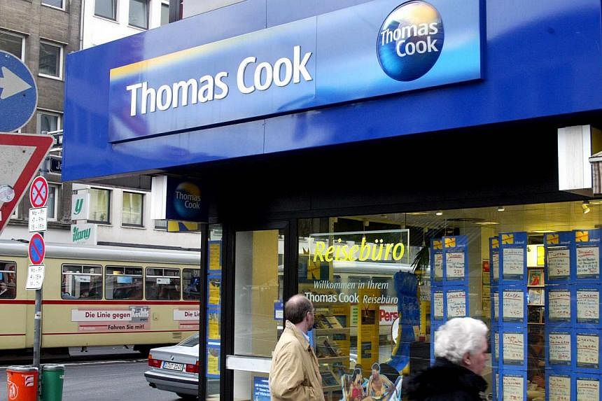 Pedestrians pass a Thomas Cook travel agency&nbsp;ocation in Duesseldorf, Germany on November&nbsp;18, 2002.&nbsp;Travel firm Thomas Cook expressed regret on Wednesday for the deaths of two British children on one of its holidays in 2006, seeking to 