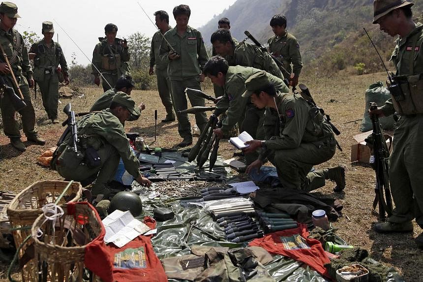 Rebel soldiers of the Myanmar National Democratic Alliance Army (MNDAA) examine weapons and ammunition at a military base in Kokang region on March 10, 2015.&nbsp;China on Wednesday said it had lodged a protest with Myanmar after shelling injured fiv