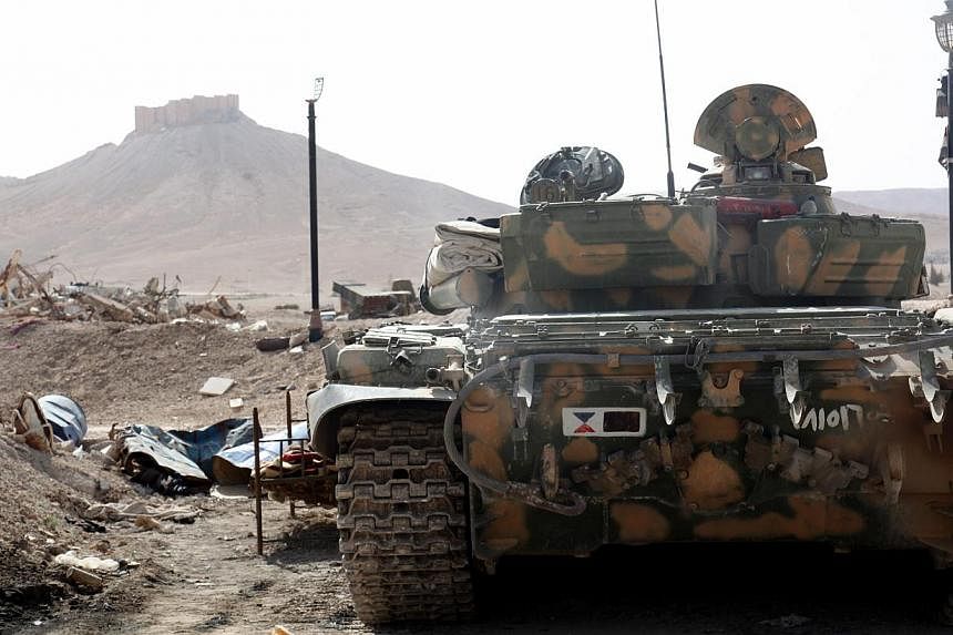 A Syrian armoured tank take up position during fightings against Islamic State in Iraq and Syria (ISIS) militants in the ancient oasis city of Palmyra, about 215km north-east of Damascus, Syria, on May 19, 2015.&nbsp;ISIS fighters seized around a thi