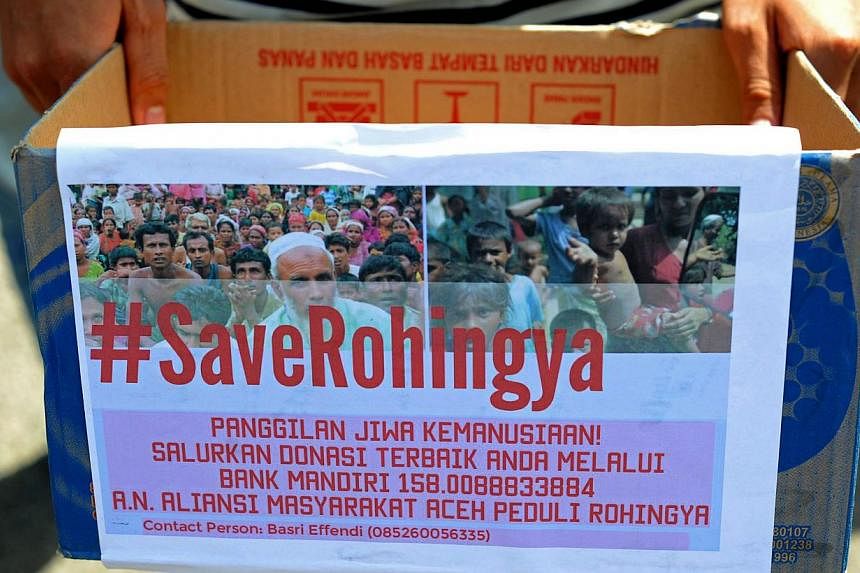 An Acehnese student holds a donation box for charity during a rally in support of Rohingya migrants in Banda Aceh on May 19, 2015. Malaysia's foreign minister was to host his Indonesian and Thai counterparts on Wednesday for urgent talks on South-eas