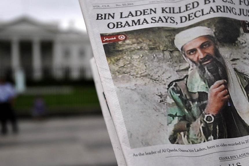A file photo taken outside the White House in Washington DC on May 2, 2011, shows a photo of Osama Bin Laden in a newspaper. Bin Laden's English language reading list included numerous books by conspiracy theorists and an inordinate number on France,