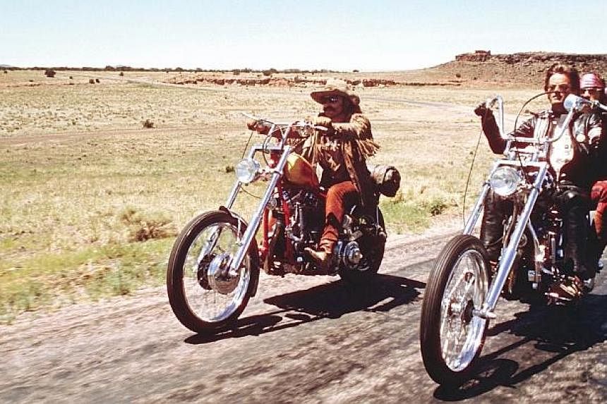 Dennis Hopper (left), Peter Fonda with Jack Nicholson riding pillion (right) in a scene from the classic movie Easy Rider. -- PHOTO: COLUMBIA PICTURES&nbsp;