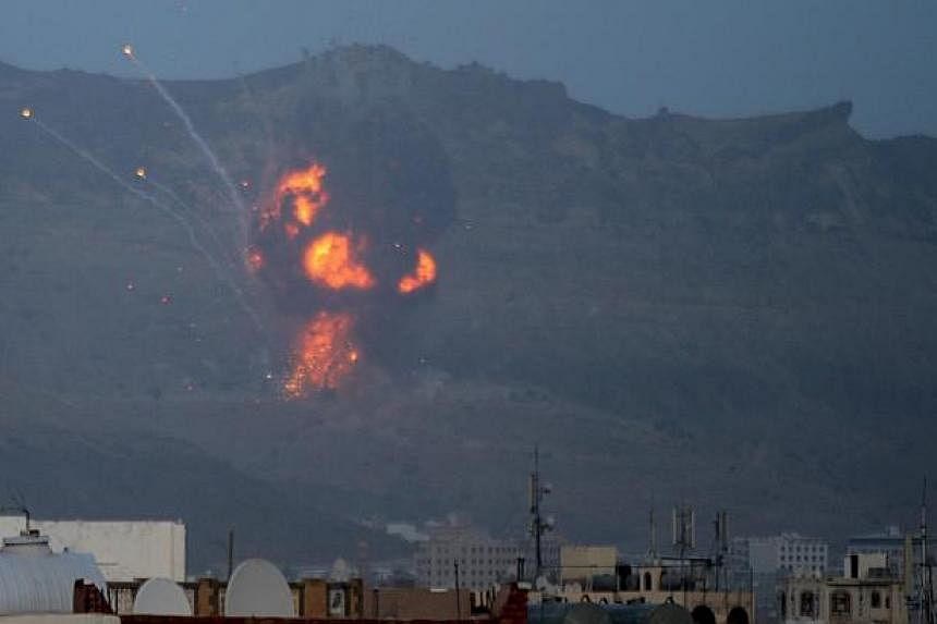 Fire is seen from the Noqum Mountain after it was hit by an air strike in Yemen's capital Sanaa May 19, 2015. -- PHOTO: REUTERS