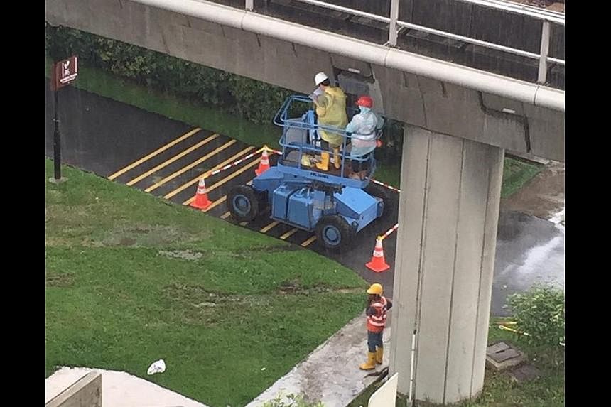 At first glance, the photo is a common sight for many Singaporeans - men working under an MRT track. But look closer and you might notice something mind-boggling. -- PHOTO: REDDIT/ZIBIN