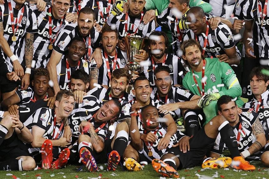 Juventus players celebrating with the Italian Cup trophy after a 2-1 win over Lazio at the Stadio Olimpico in Rome. -- PHOTO: REUTERS&nbsp;