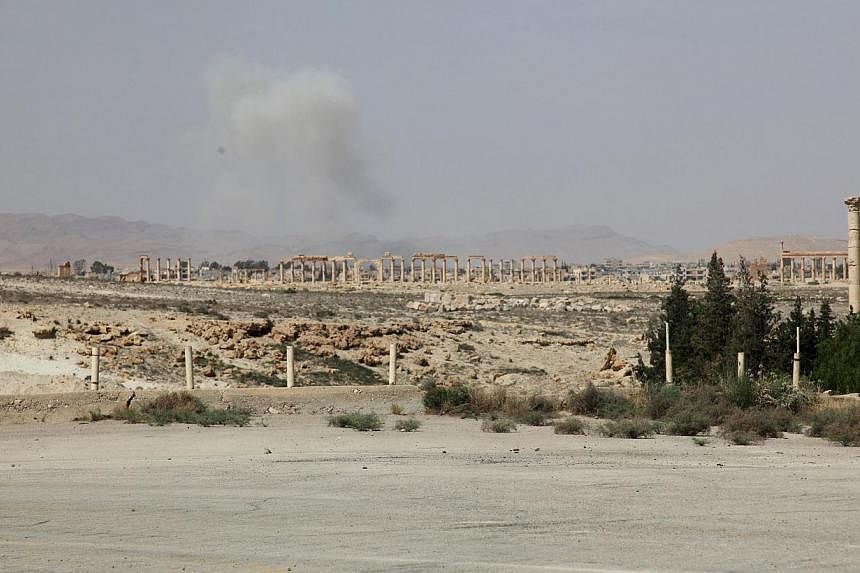 Smoke from what activists said was the result of shelling from Islamic State fighters on Palmyra city, Syria, on May 19, 2015. -- PHOTO: REUTERS